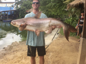 Cameron holding a big fish in BoSang Fishing Park, Thailand