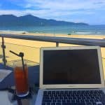 Laptop and drink near a beach in Da Nang, Vietnam