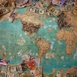 Money from different countries with a world map