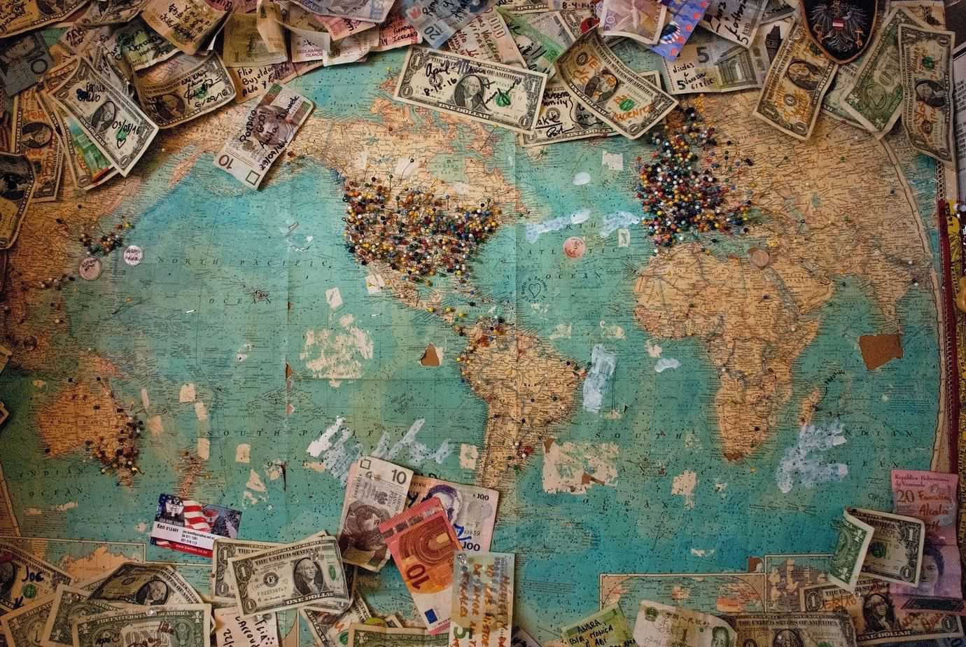 Money from different countries with a world map