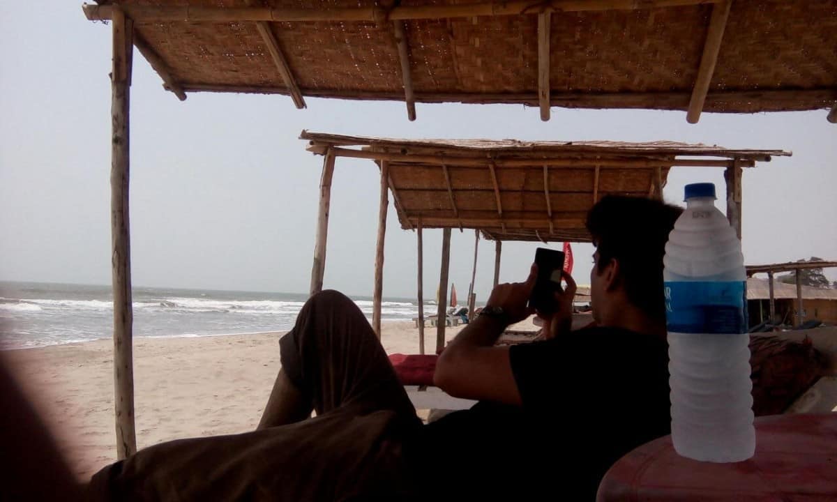 ashish on the beach with a bottle of water