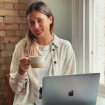 Lucy Johnson with her computer and coffe