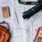 Camera, pencil, bag, books and notepad on top of Salisbury District, England