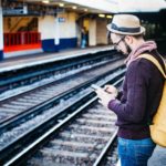 Person using phone while waiting for train