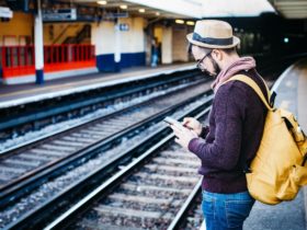 Person using phone while waiting for train