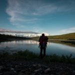 Man standing in front of body of water