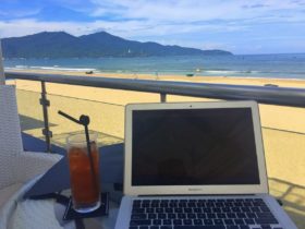 Laptop and drink near a beach in Da Nang, Vietnam