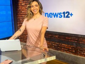 Michelle Marie smiling in news12+ while wearing a pink dress