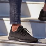 Man wearing a pair of shoes Allbirds Men's Wool Runners in Natural Black while in stairs