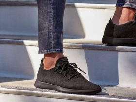 Man wearing a pair of shoes Allbirds Men's Wool Runners in Natural Black while in stairs