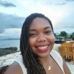 Juleen smiling while in a beach restaurant