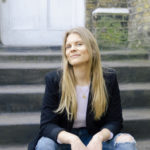 Maria Eilersen sitting in stairs in front of a brick house