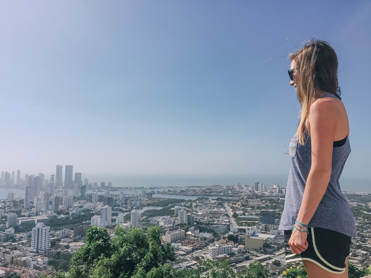 A side view of Anny Wooldridge as she stands on a hill that overlooks the city of Cartagena
