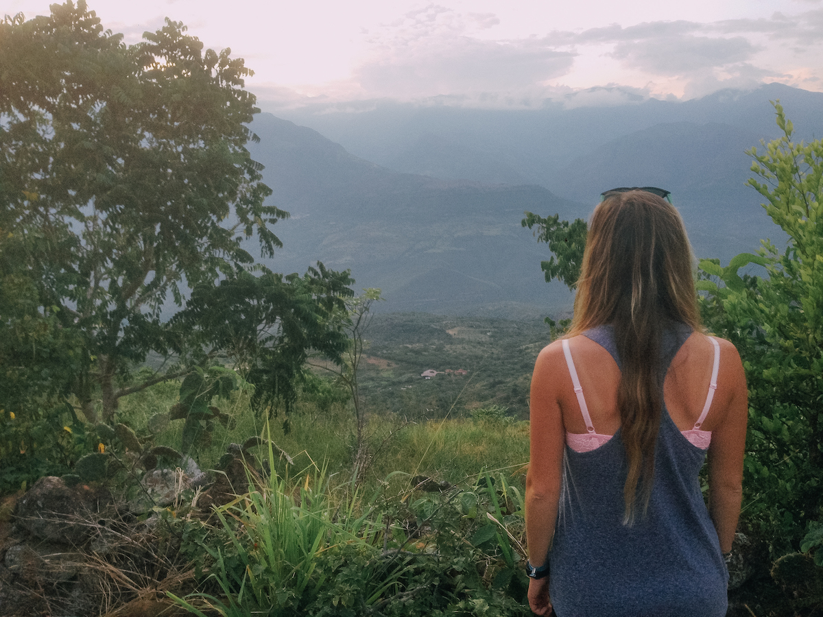 Anny Wooldridge's back as she overlooks a lush tropical valley in barichara