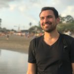 Michael Alexis smiling on a beach in Bali