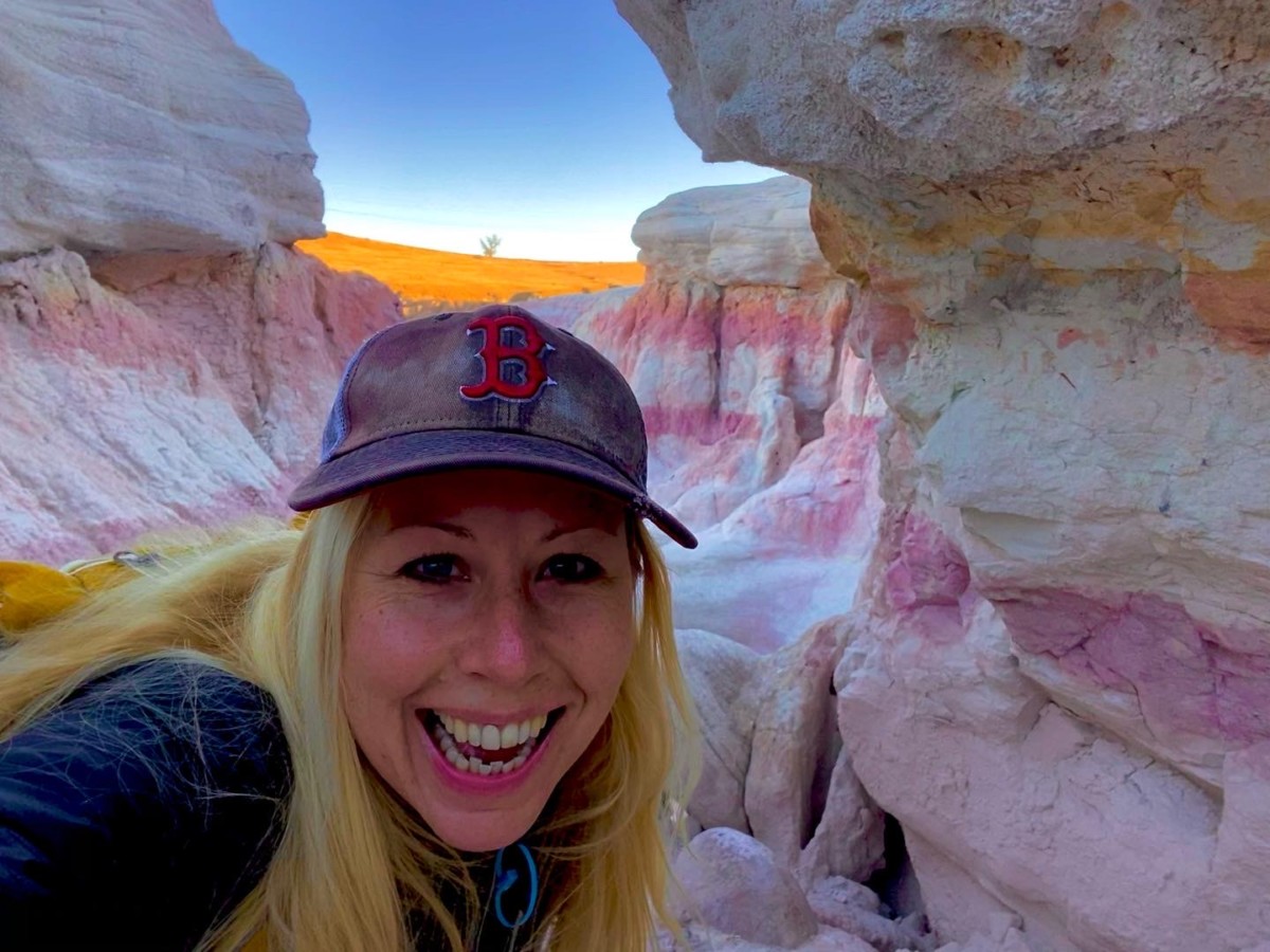 Angela Faith Martin smiling in front of colorful rock formation