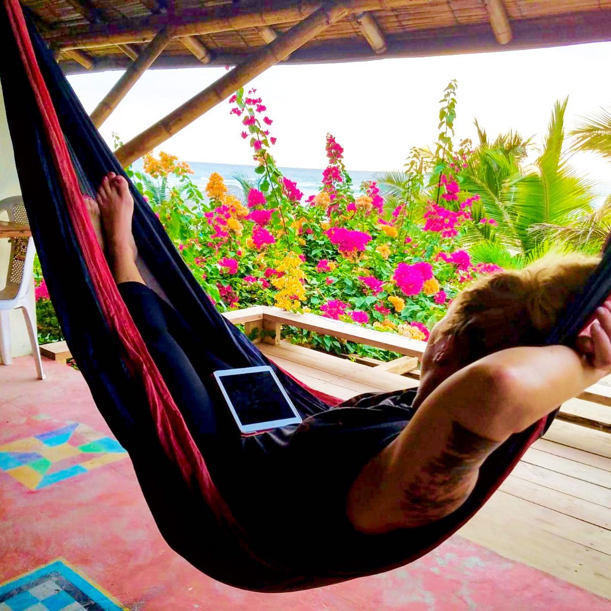 Angela Faith Martin laying in a hammock with a Kindle in her lap