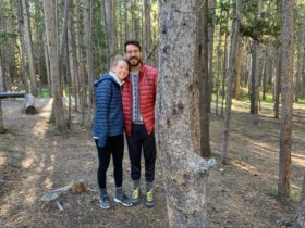 Becca and Brandon together in the woods while wearing warm clothing