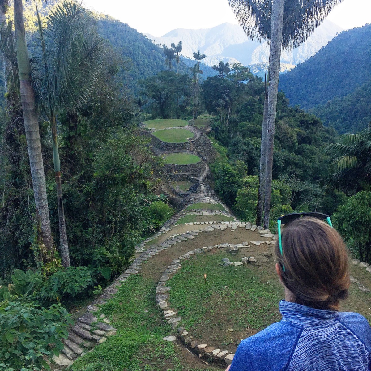 The back of Anny Wooldridge's head while she looks over a terraced area in the lost city of Columbia