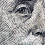 Close up of Benjamin Franklin's face on the 100 dollars bill