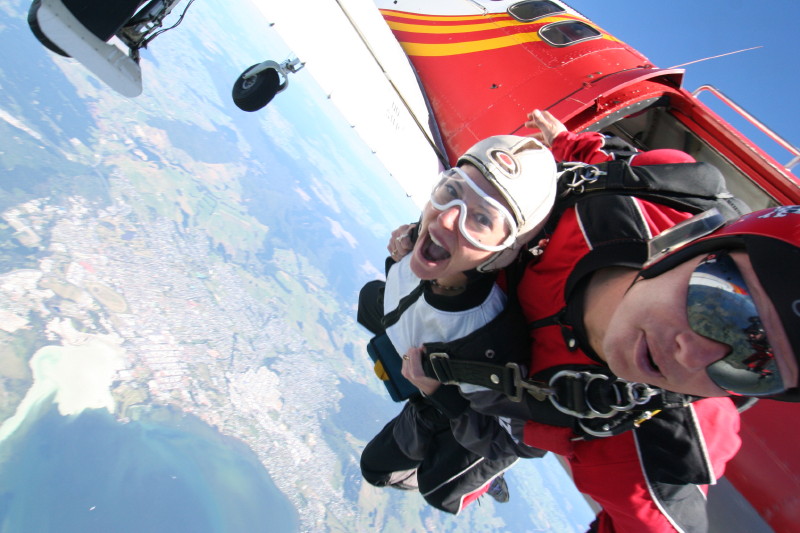 A women skydiving in New Zealand poses with her mouth open