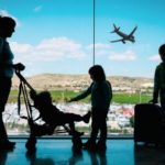 A mom and three kids at the airport