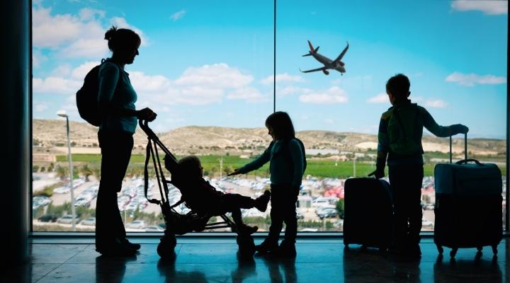 A mom and three kids at the airport