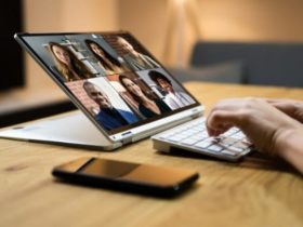 CEO in front of their laptop, talking to 6 employees via video call