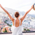 Young female traveler enjoying the great view of the city and harbor of Monte Carlo, Monaco