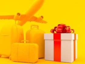 Yellow luggages beside a gift box