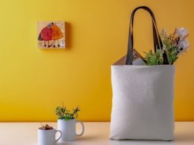 Travel tote bag filled with numerous items on a table