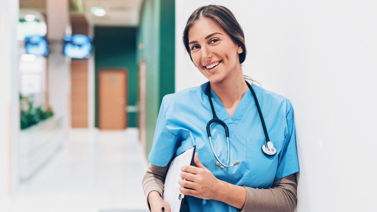 Young female nurse with a clipboard on a hospital hallway